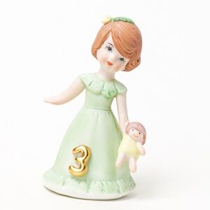 Growing Up Birthday Girl Green Dress Figurine Age 3 Brunette holding doll